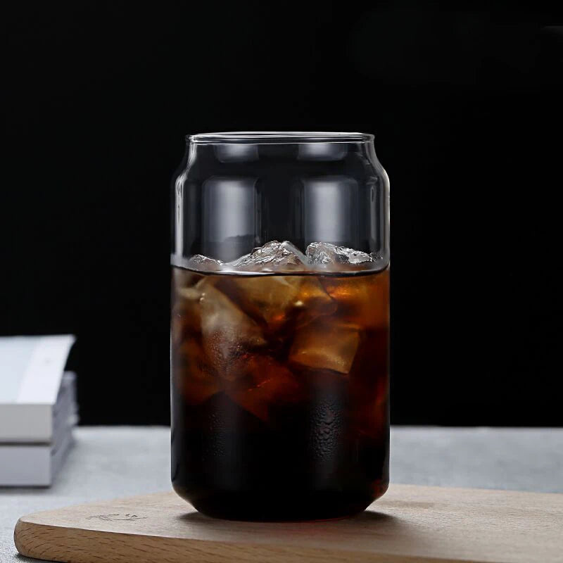GLASS with iced coffee on a wooden board against a dark background