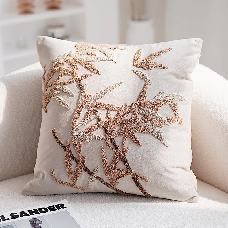 Decorative pillow with leaf pattern on a couch