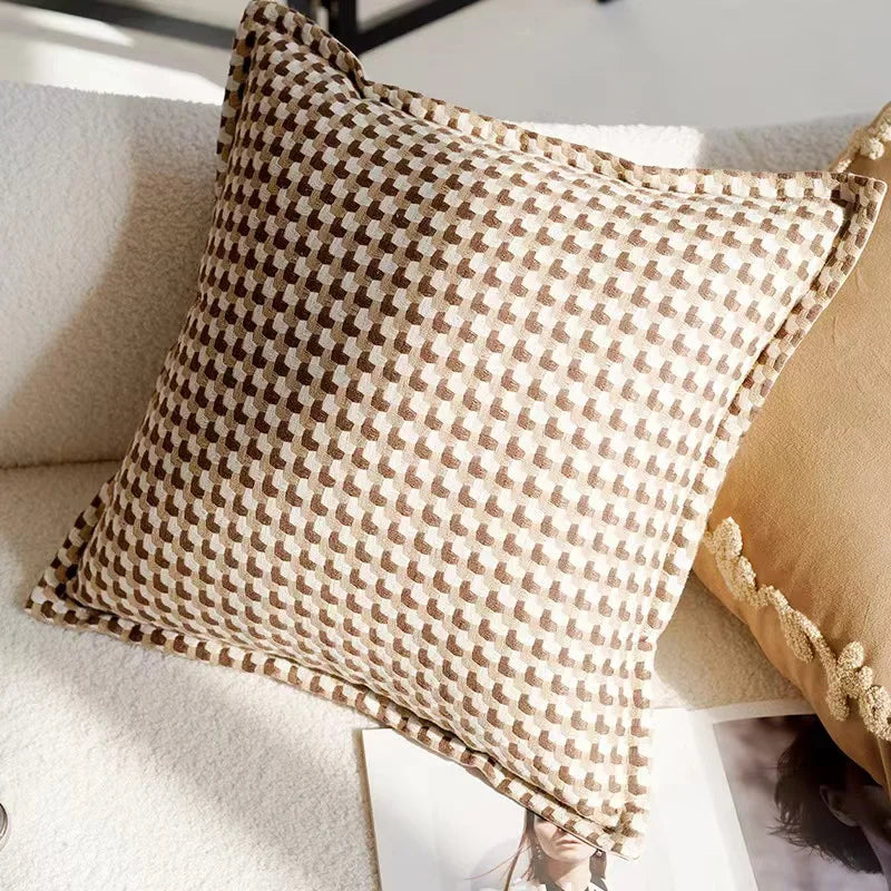 Patterned pillow on a sofa with a neutral background