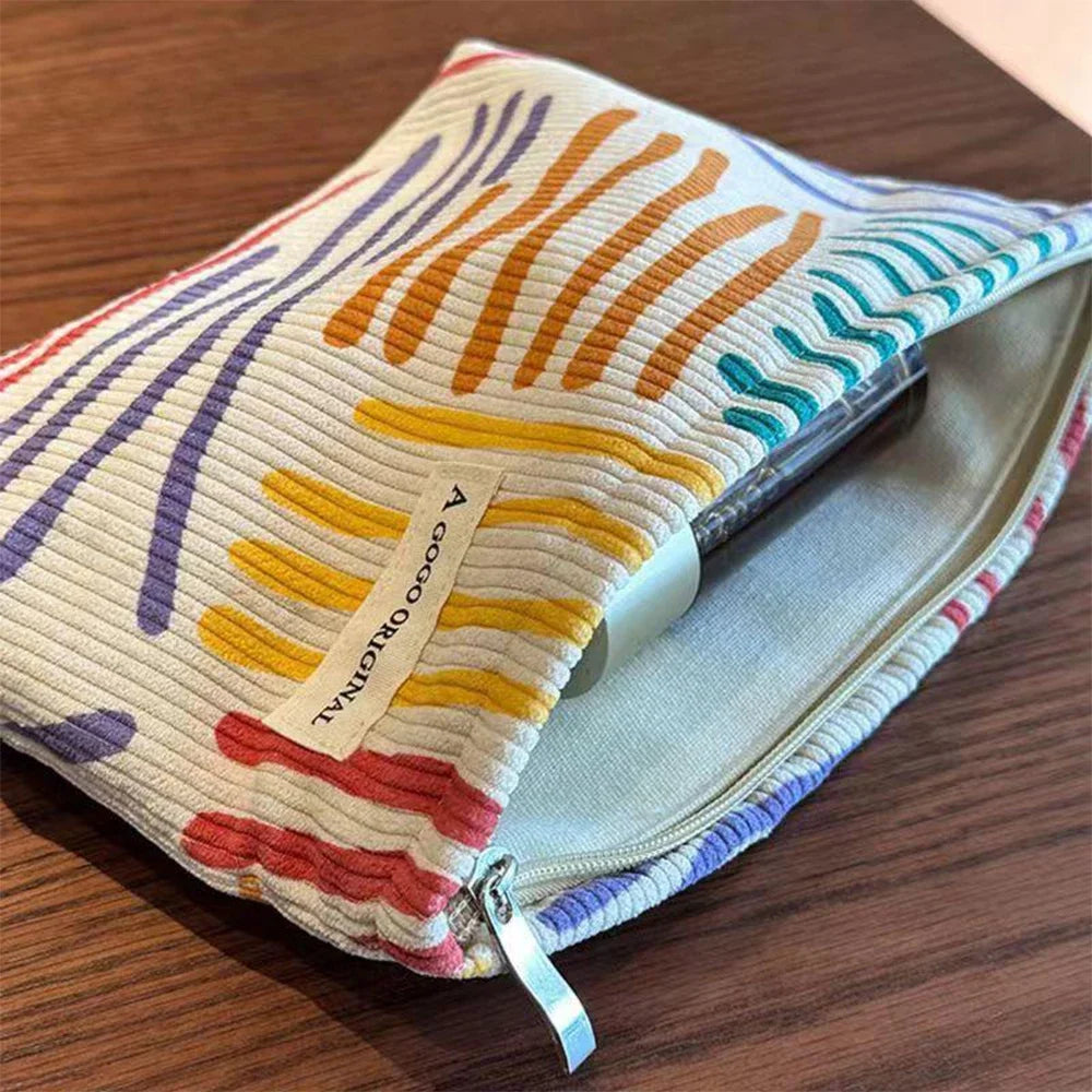 Colorful pouch with abstract patterns on a wooden surface