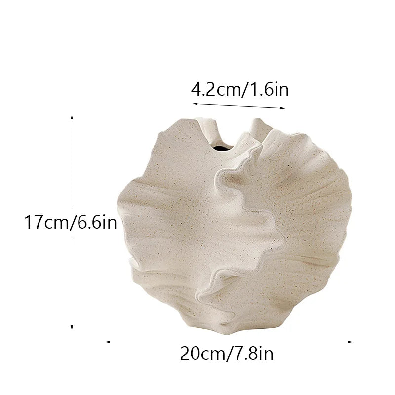 Beige shell-shaped vase with measurements on a white background