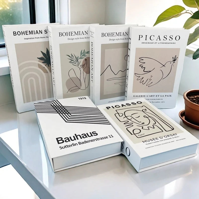 Collection of books with artistic designs on a white surface