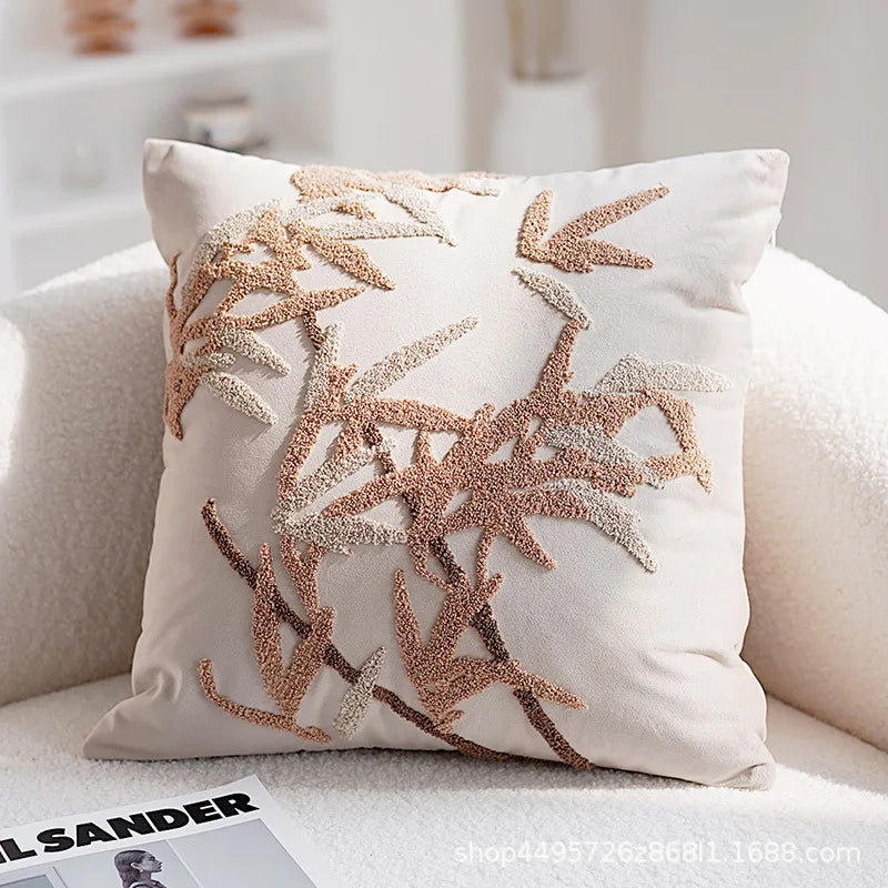Decorative pillow with leaf pattern on a couch