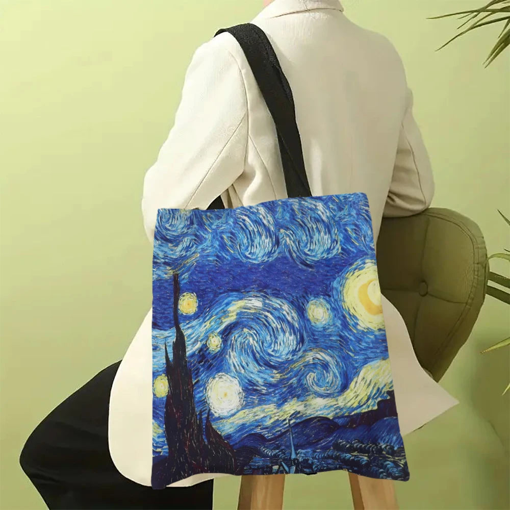Person carrying a tote bag with 'Starry Night' design against a green background