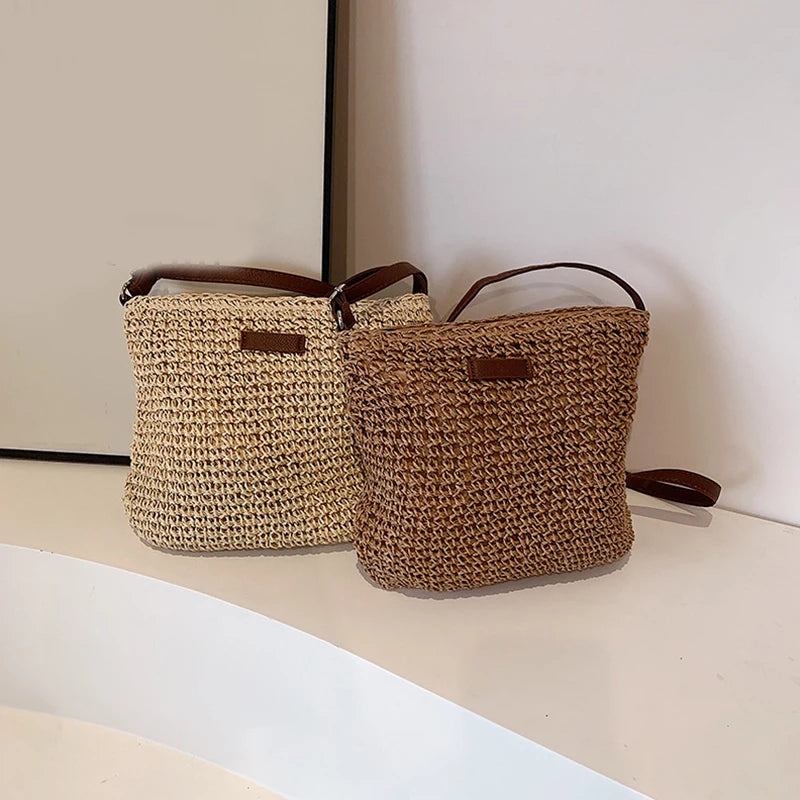 Two woven baskets with handles on a light surface.