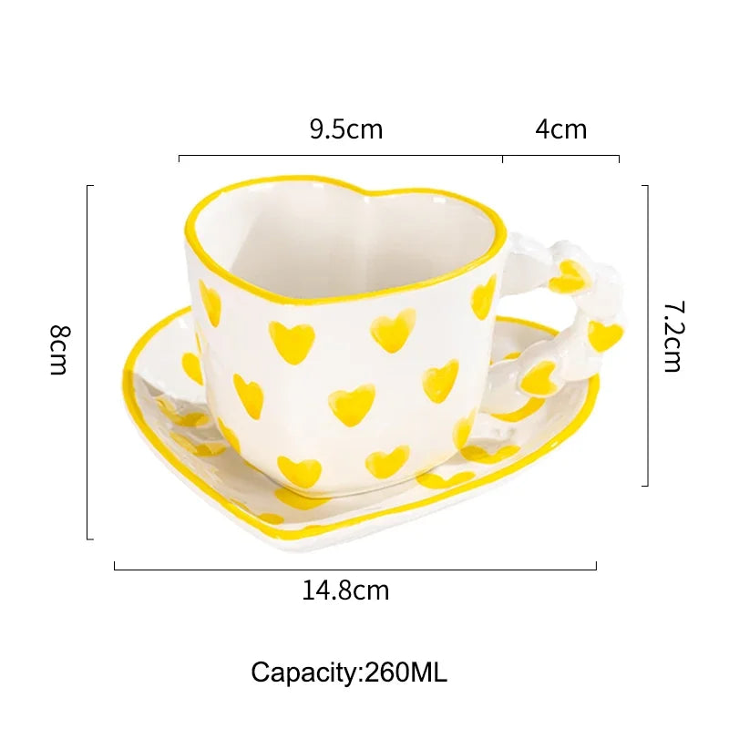 Heart-shaped ceramic cup with yellow heart patterns on a white background, showing measurements and capacity.