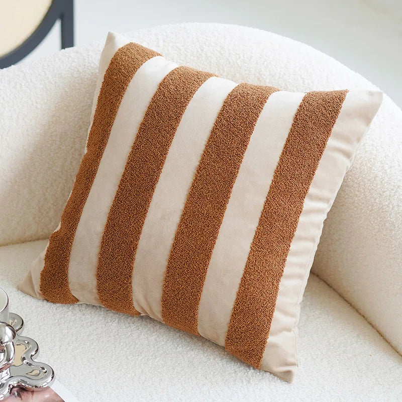 Striped pillow with brown and beige stripes on a white sofa