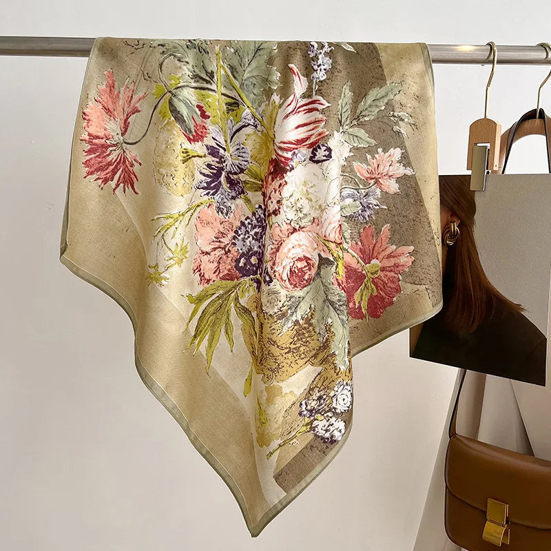 Floral patterned scarf on a rack with a handbag in the background