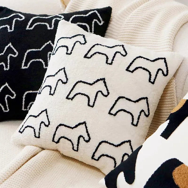 Decorative pillows with horse patterns on a neutral background