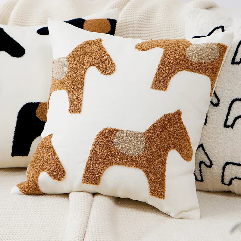 Decorative pillow with horse pattern on a textured surface