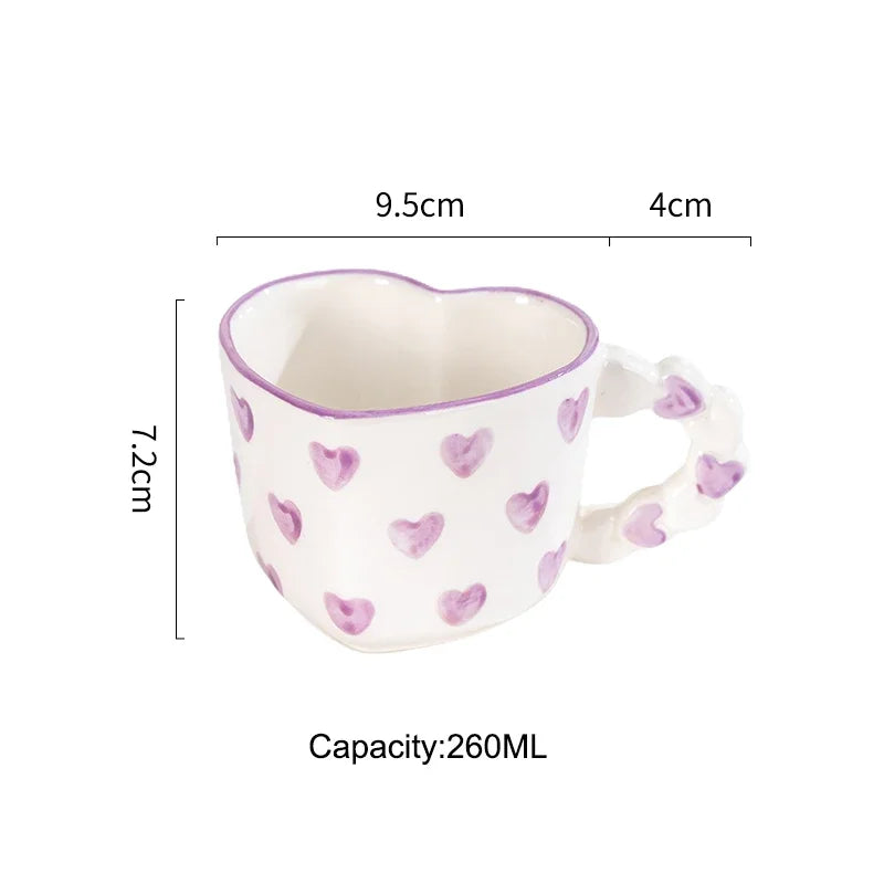 Heart-shaped mug with pink heart patterns and measurements on a white background