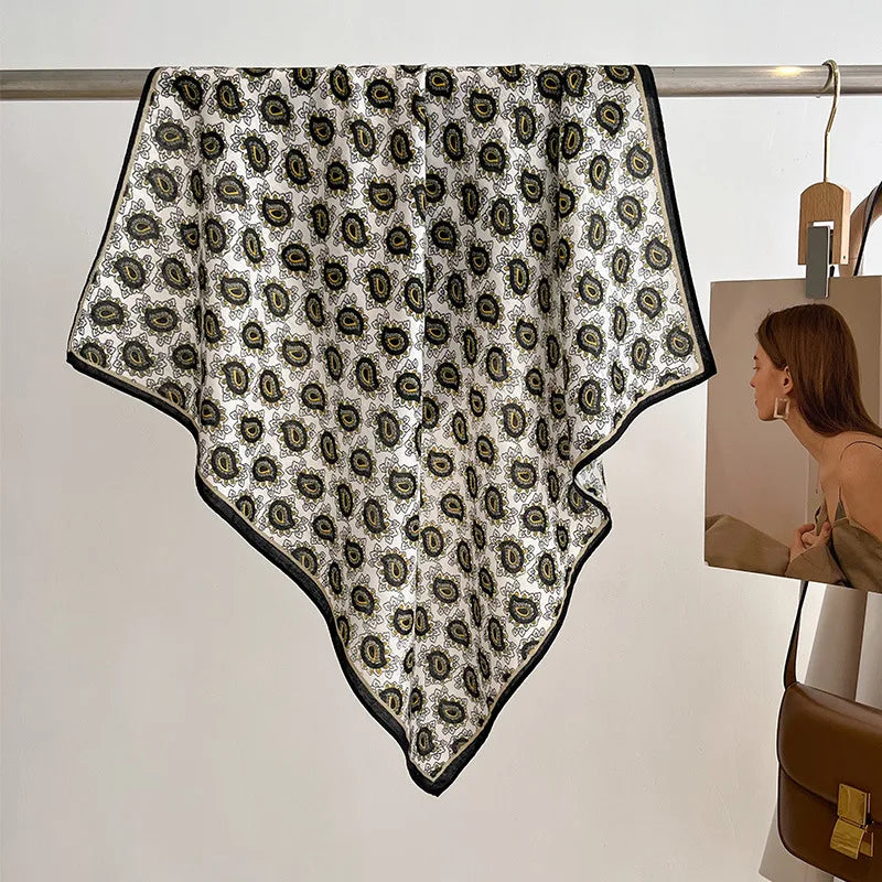 Patterned scarf on a hanger with a handbag in the background