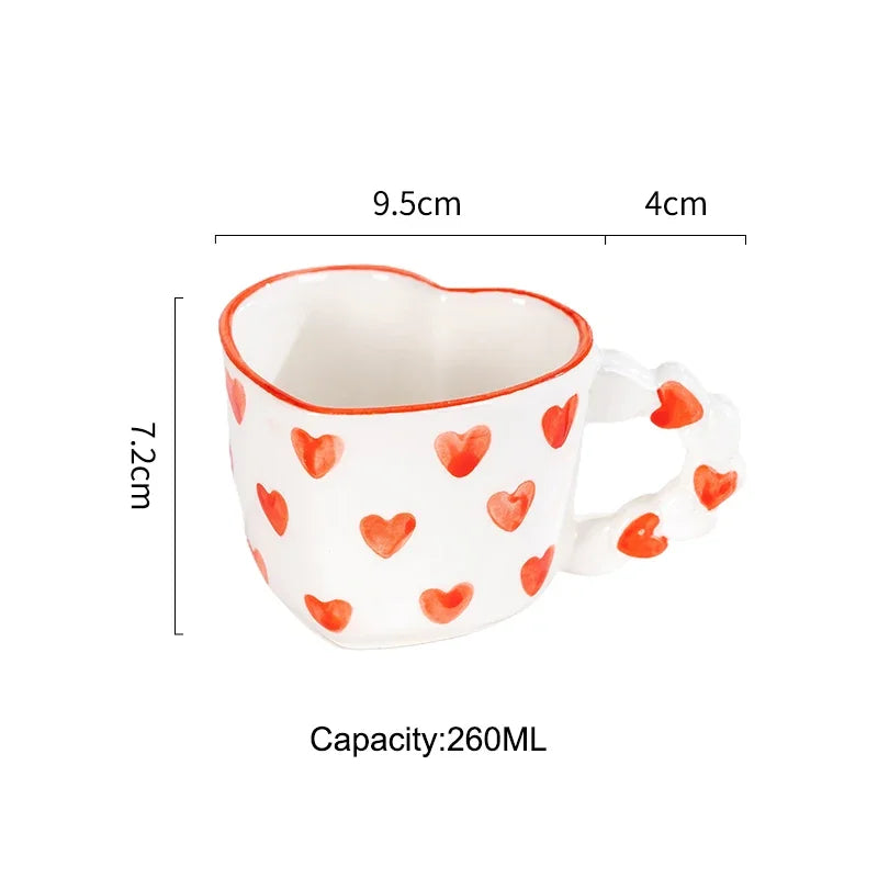 Heart-shaped mug with red heart patterns and measurements on a white background
