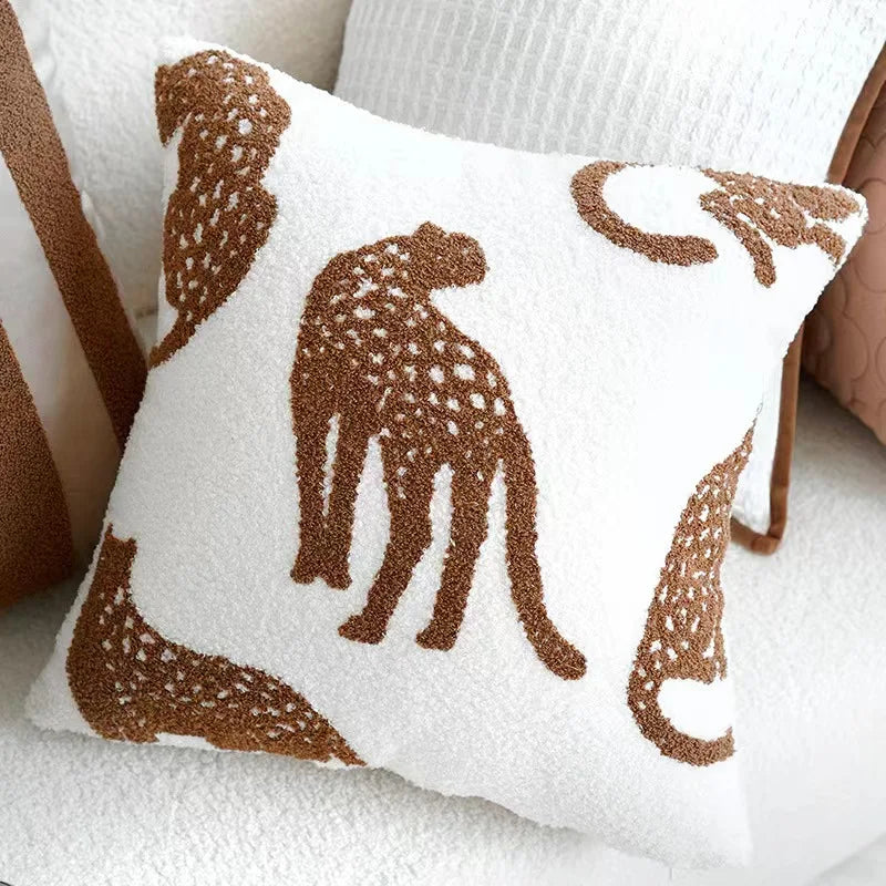Decorative pillow with brown cheetah patterns on a white background