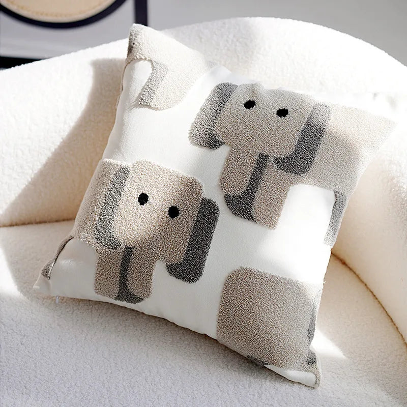 Decorative pillow with elephant pattern on a white surface