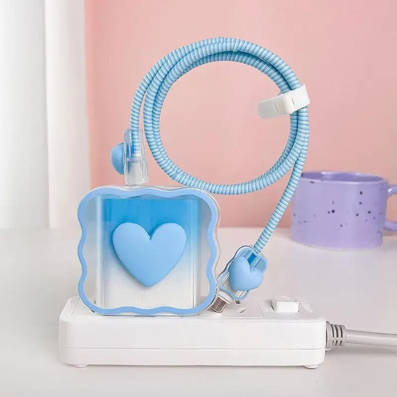 Blue heart-shaped charger head protective sleeve on a white surface with pink background