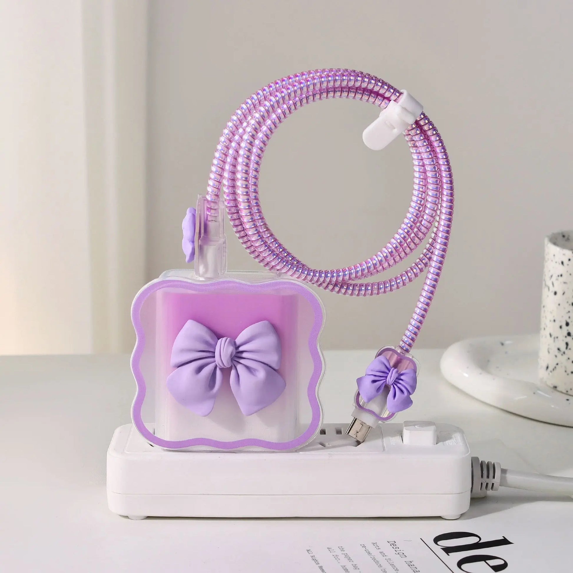 Purple charger head protective sleeve with a bow design on a white surface