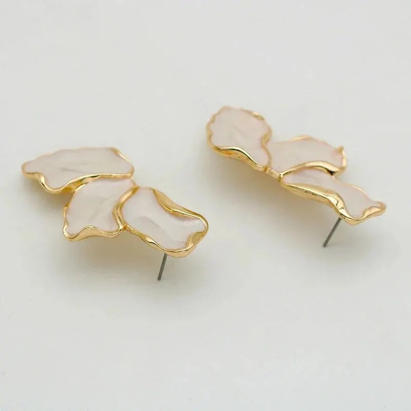 Pair of earrings with gold accents on a light gray background