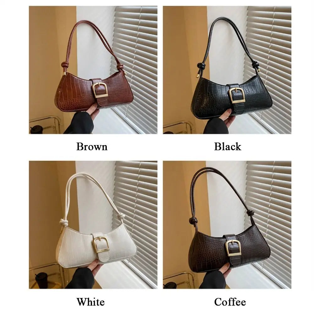 Four different colored handbags held by a person against a window blinds background.