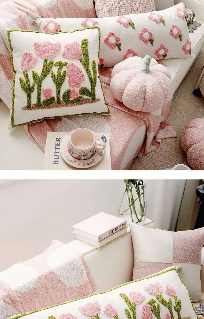 Decorative pillows with floral patterns on a couch.