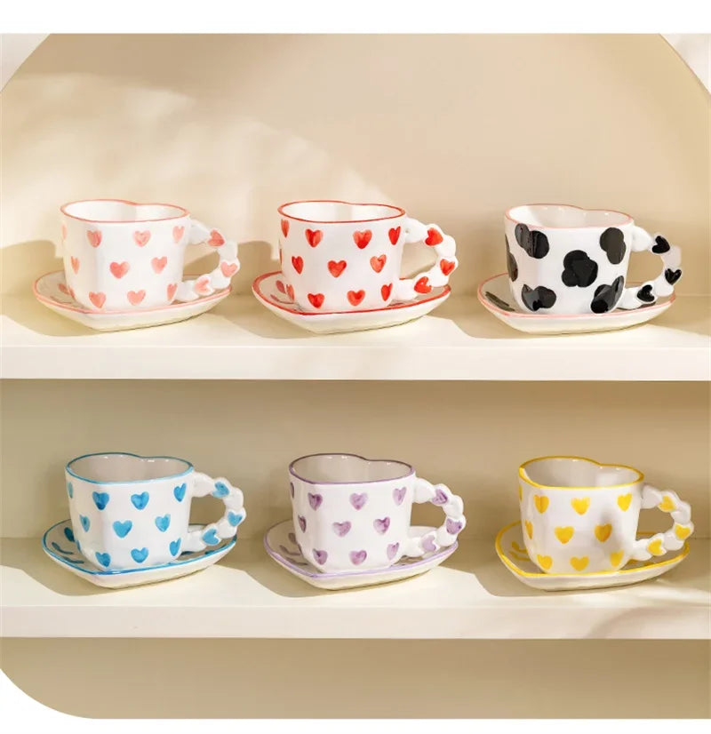 Set of ceramic cups and saucers with various patterns on a beige shelf.