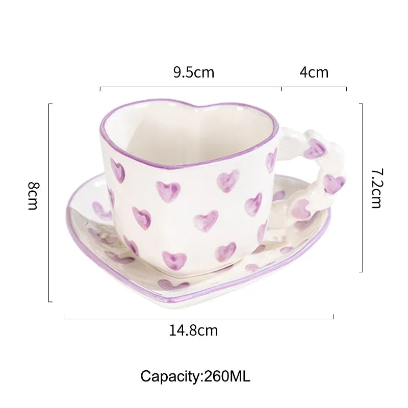 Heart-shaped ceramic cup with saucer and measurements on a white background