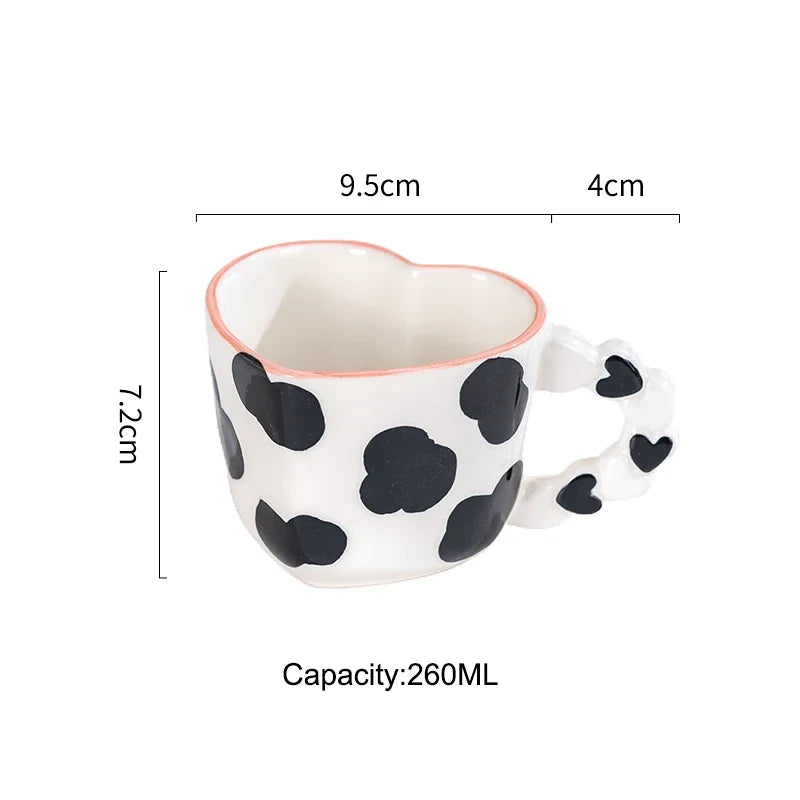 Heart-shaped mug with black polka dots and measurements on a white background