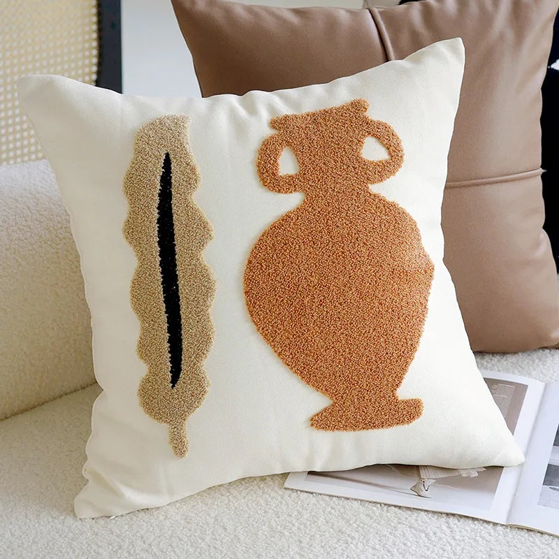 Decorative pillow with textured vase design on a couch