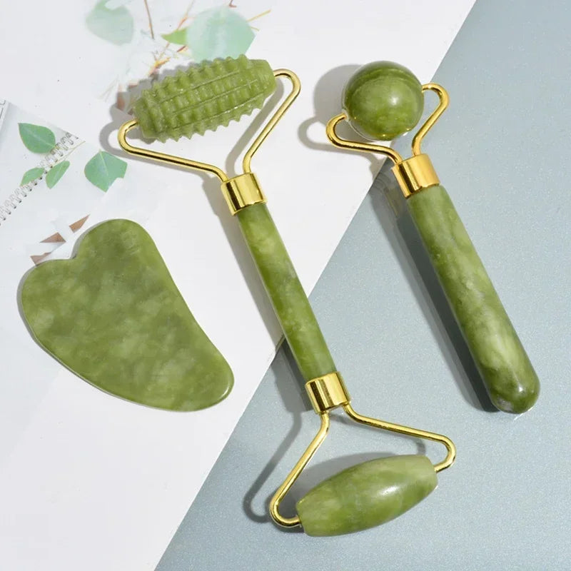 Set of green facial tools with gold accents on a light blue and white background