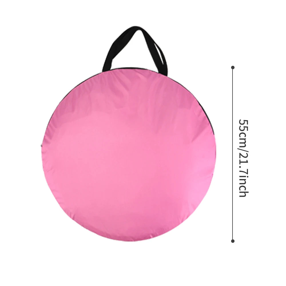Pink round seat pad with black handle and measurements on a white background