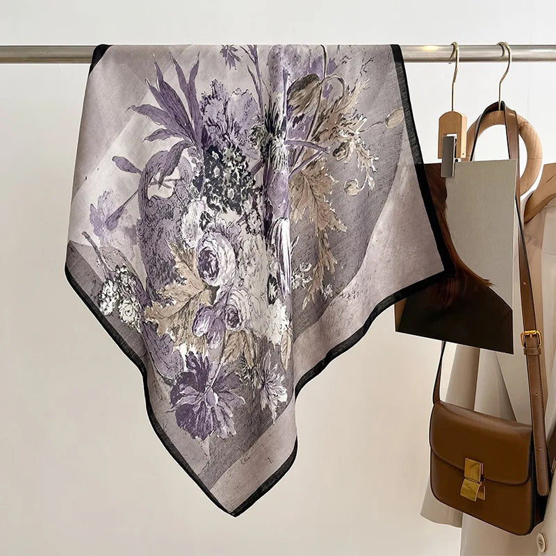 Floral patterned scarf on a rack with a brown handbag in the background