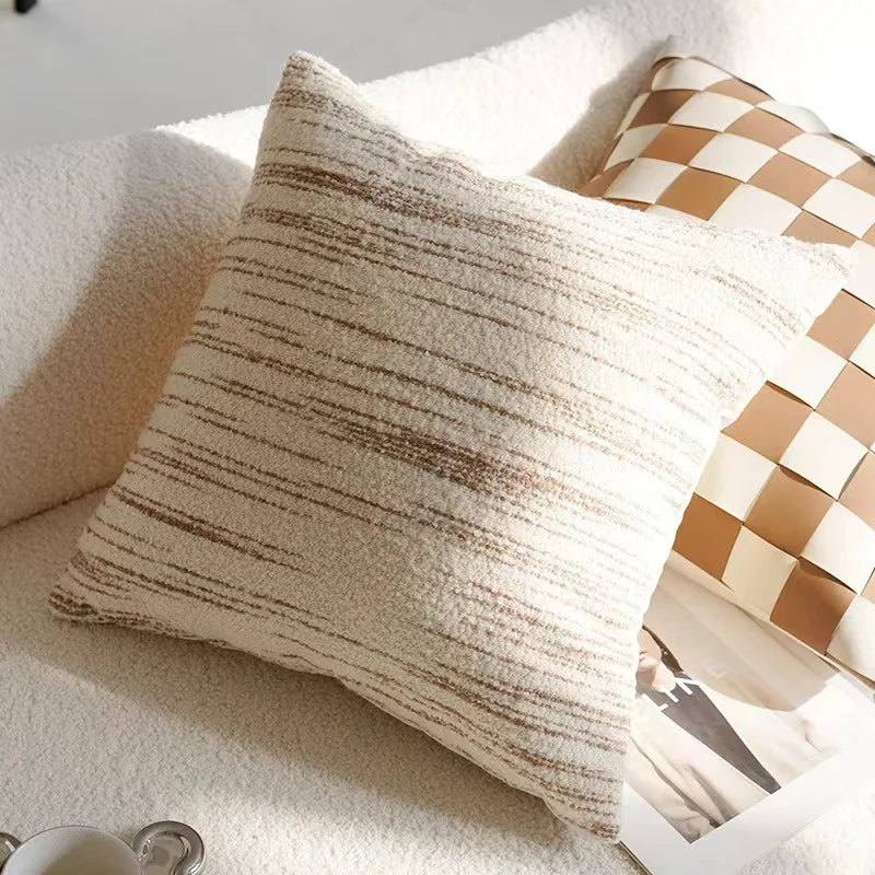 Textured throw pillow on a sofa with a checkered pillow in the background