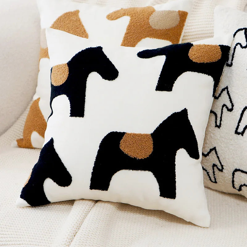 Decorative pillow with horse pattern on a couch