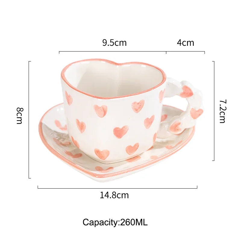 Heart-shaped ceramic cup with saucer and measurements on a white background