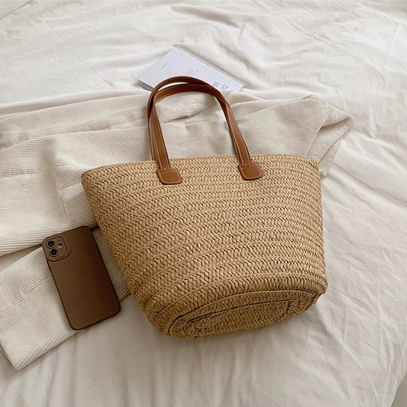 Woven handbag with brown handles on a white surface