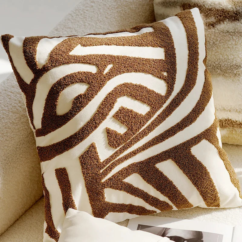 Decorative pillow with brown and white pattern on a beige sofa