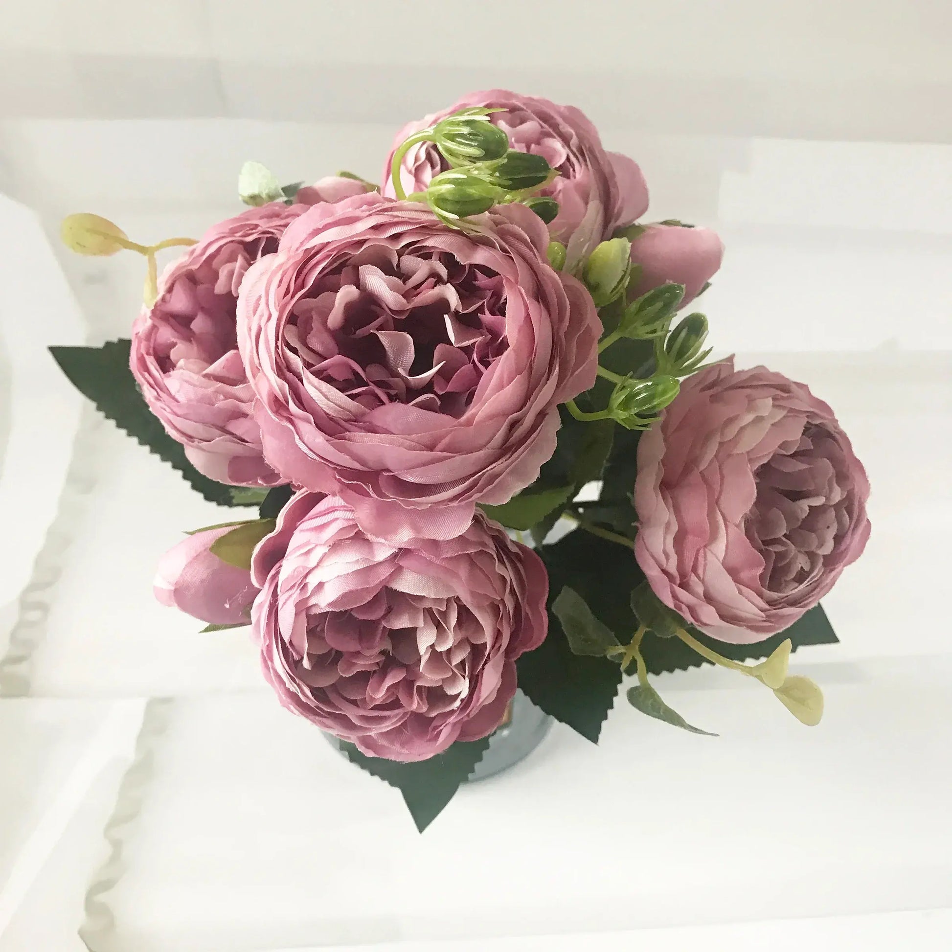 Add timeless beauty to your space with this stunning rose silk peony bouquet. Made with high-quality silk, it features 5 full peony blooms.
