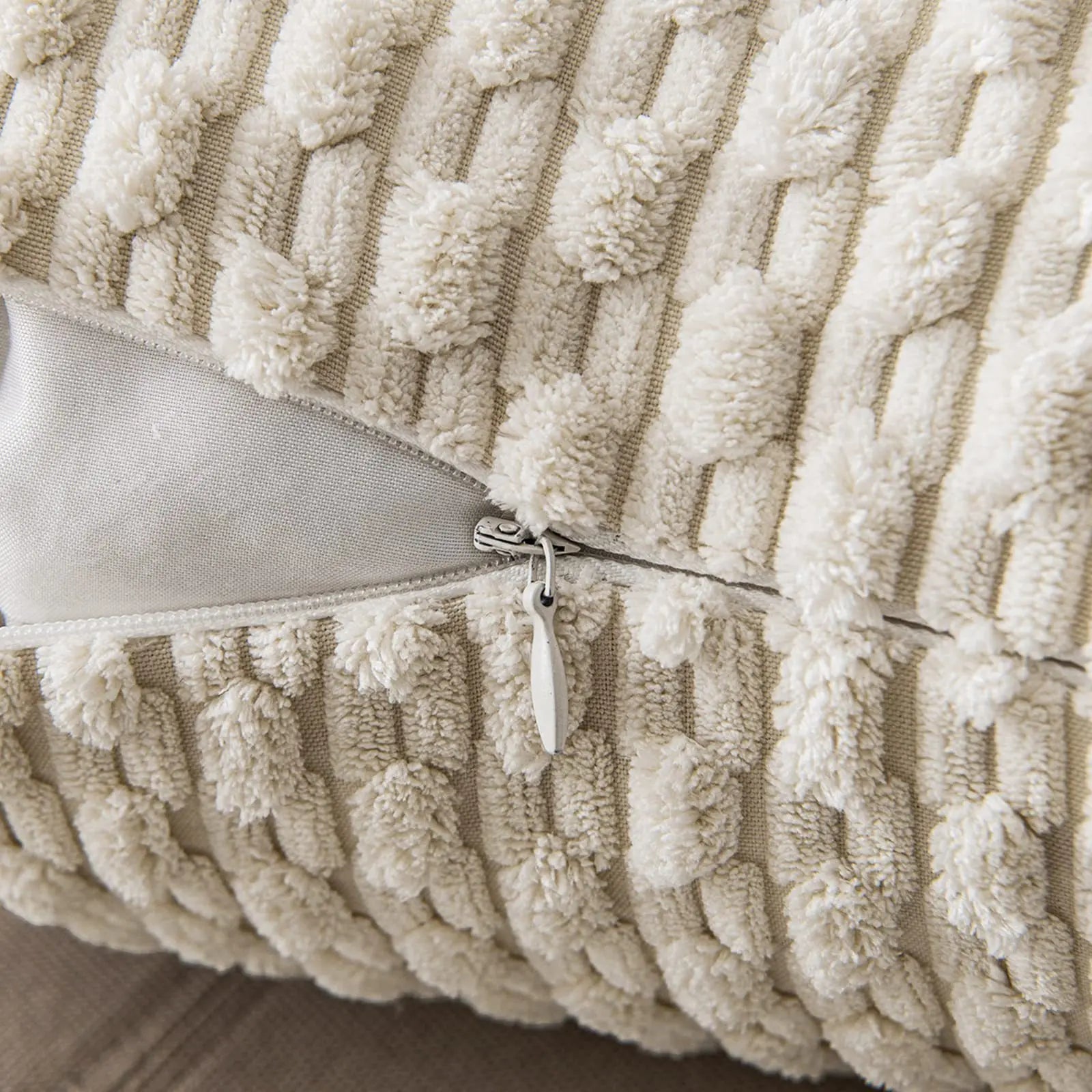 Close-up of a textured beige pillow with a zipper