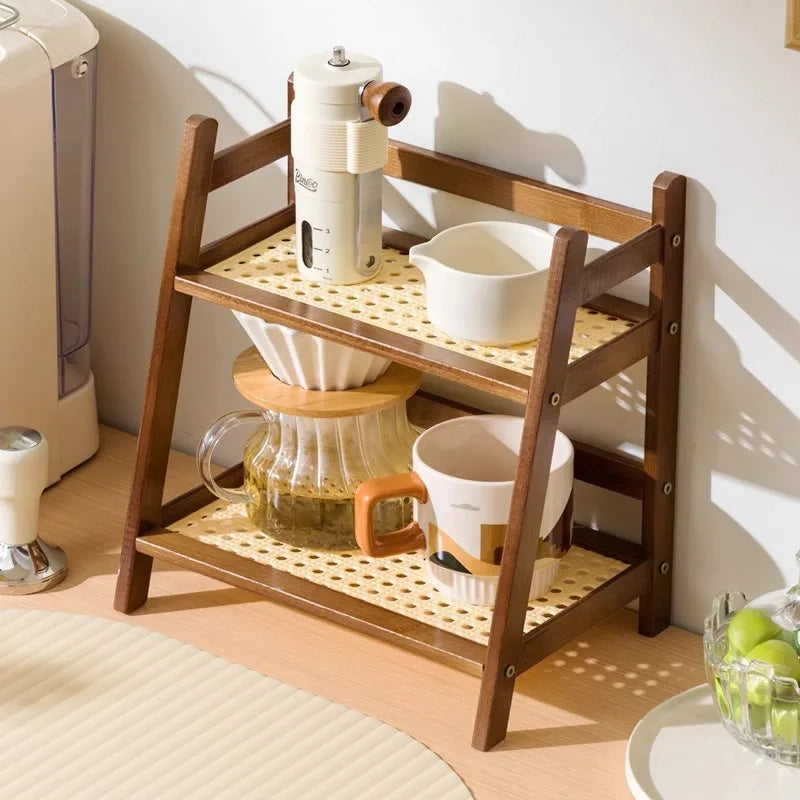 Wooden shelf with kitchen items including a coffee maker, cups, and a pitcher on a light wooden floor.