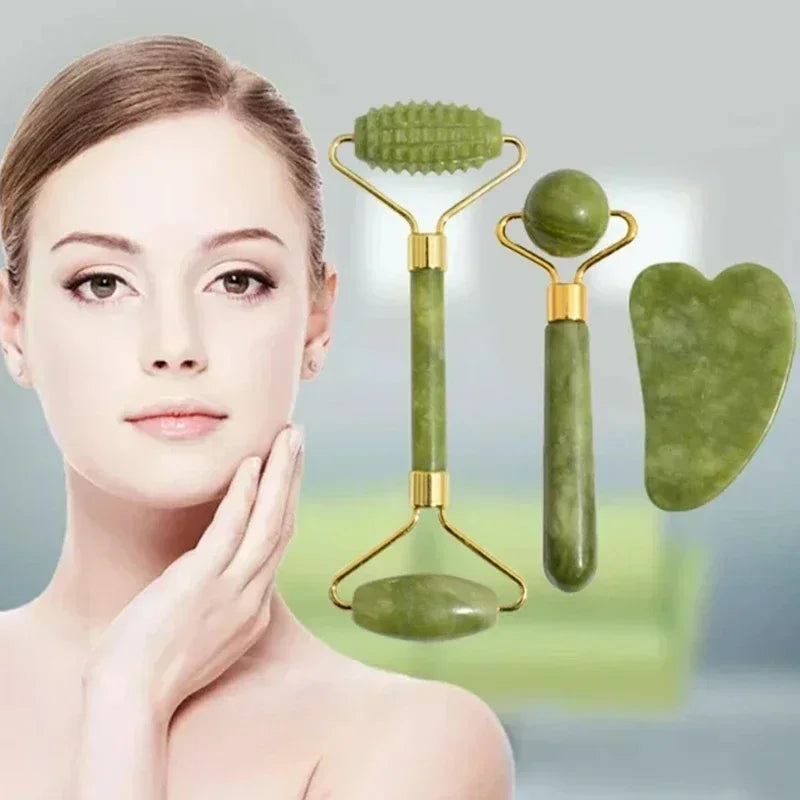 Woman touching her face with a green jade roller and gua sha tool on a gray background