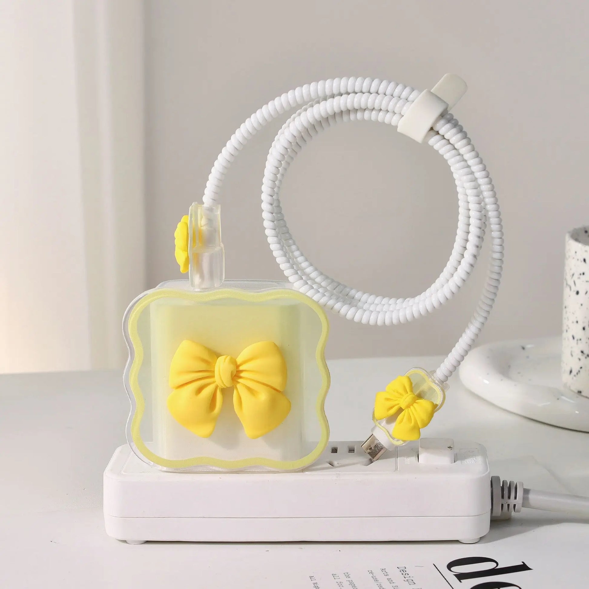 charger head protective sleeve with yellow bow design on a white surface