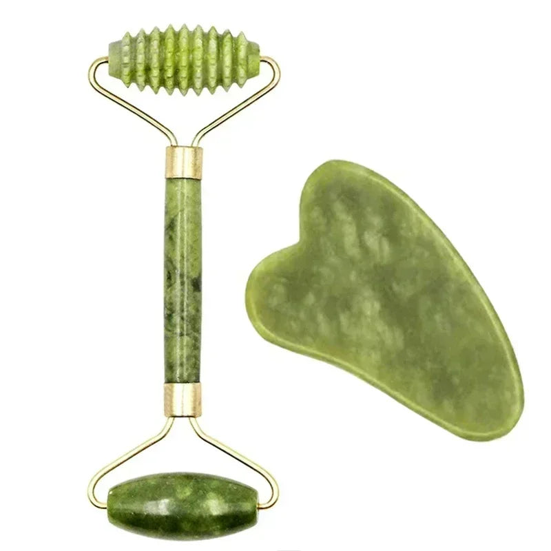 Green jade roller and gua sha tool on a white background