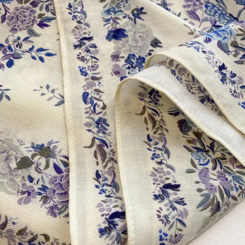 Floral fabric with blue and purple flowers on a white background