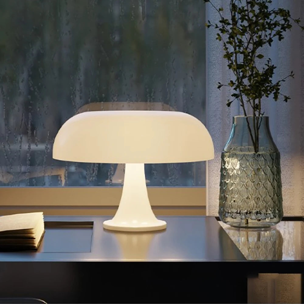 Table lamp on a desk with a vase and book in a room setting