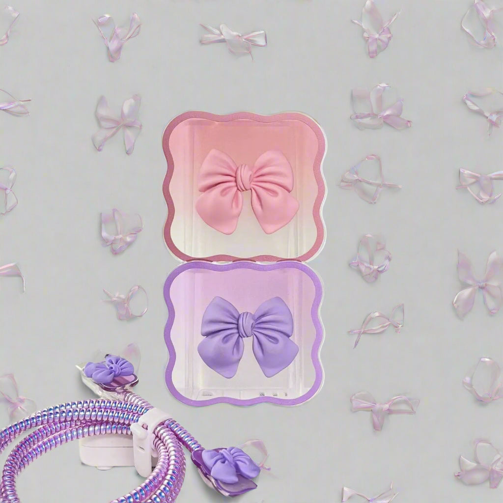 Pink and purple bow-shaped phone chargers protector head on a white surface