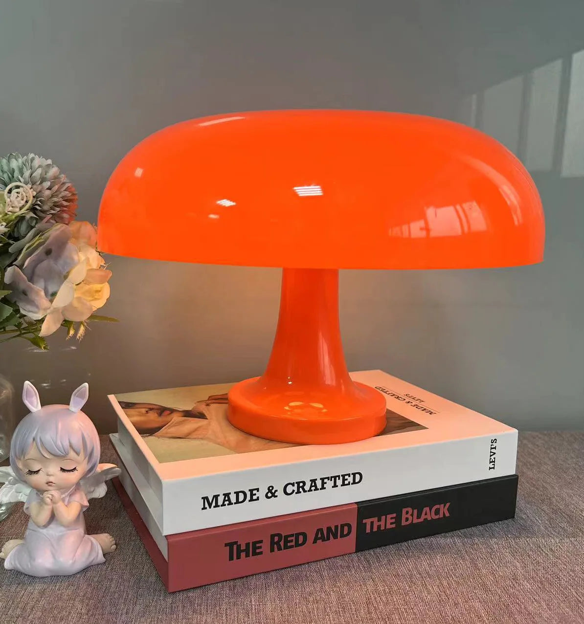 Orange lamp on a book with decorative items around