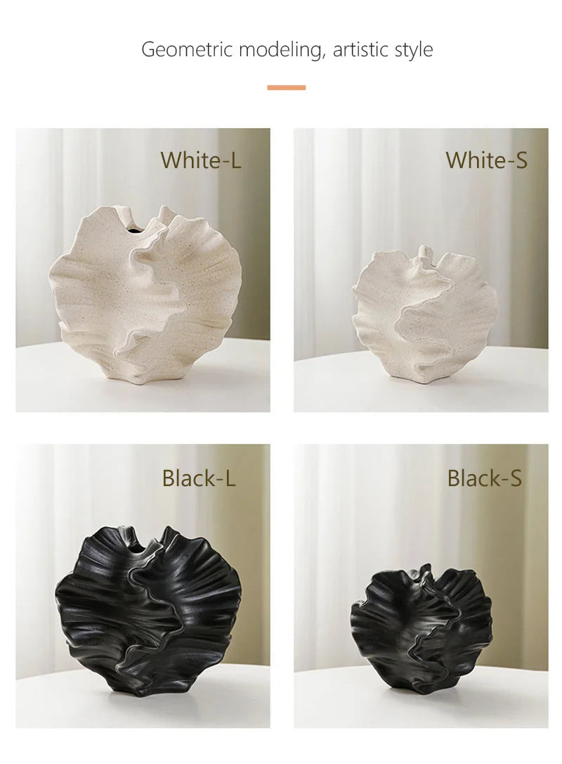 Four geometrically modeled vases in white and black on a neutral background