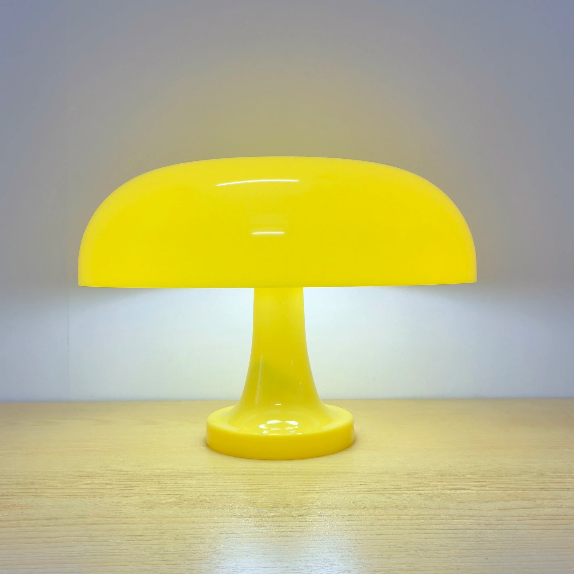 Yellow table lamp on a wooden surface with a neutral background