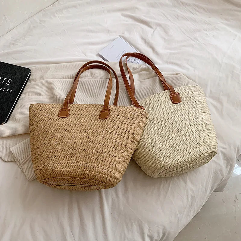 Two woven bags with brown handles on a white surface