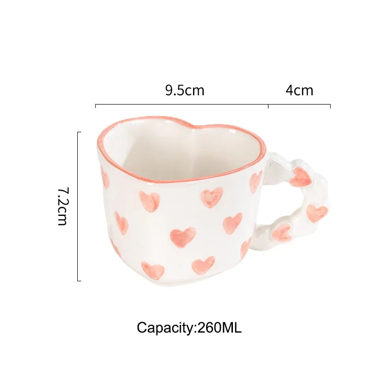 Heart-shaped mug with pink heart patterns and measurements on a white background
